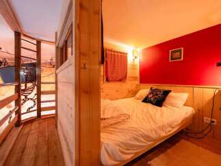 Cozy cabin bedroom with a unique wooden design and a comfortable bed.
