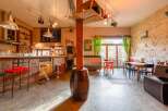 Rustic-chic bar and restaurant with exposed stone walls and eclectic decor.