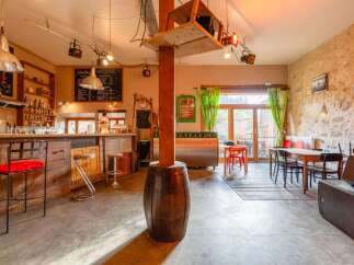 Rustic-chic bar and restaurant with exposed stone walls and eclectic decor.