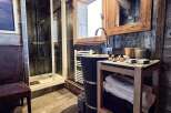 Luxury chalet bathroom boasts a spacious shower, stylish wooden vanity, and plush towels.