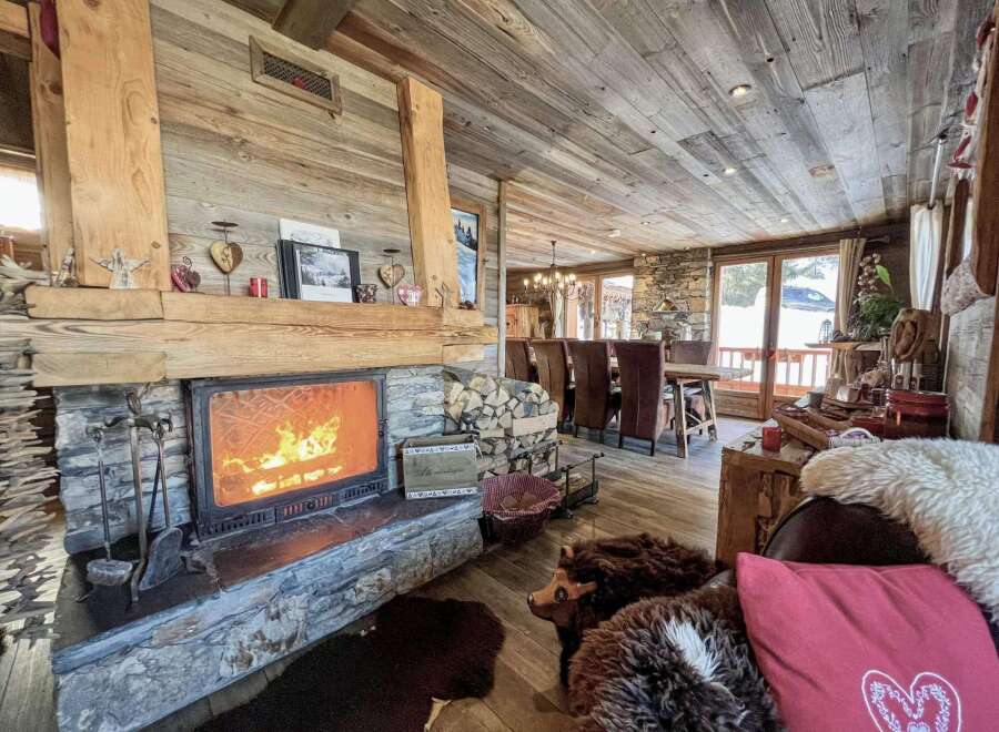 Cozy chalet with a stunning stone fireplace, perfect for relaxing winter evenings.