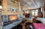 Cozy chalet with a stunning stone fireplace, perfect for relaxing winter evenings.