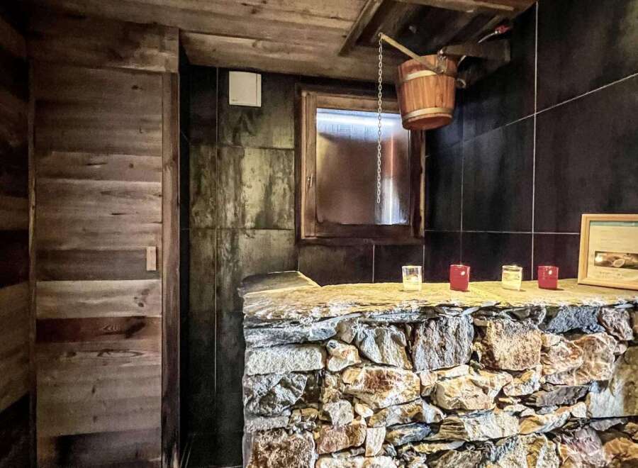 This luxurious chalet boasts a stunning sauna with a rustic-chic design.