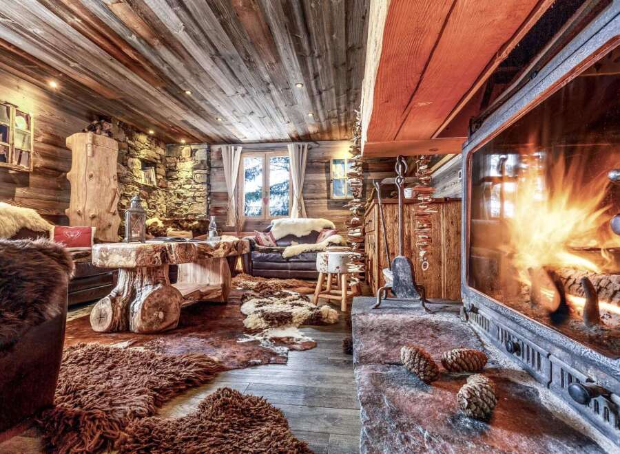 Cozy up by the fireplace in this rustic chalet, featuring a wood-burning stove and stunning mountain views.