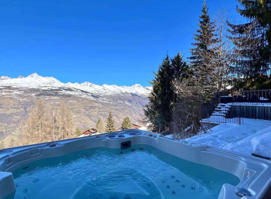 Luxury chalet with stunning mountain views and a private hot tub.
