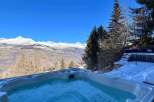 Luxury chalet with stunning mountain views and a private hot tub.