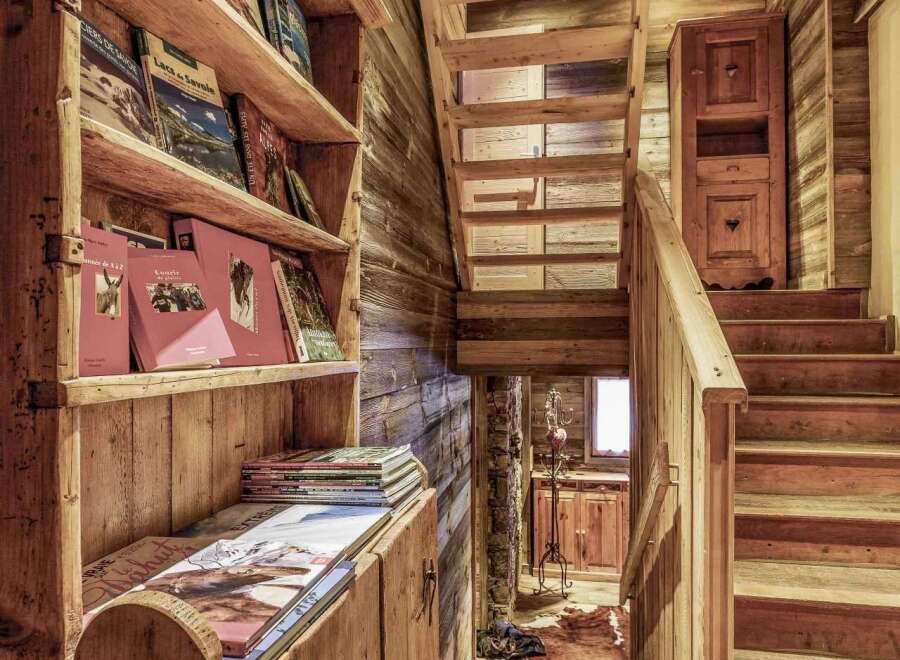 Rustic wooden staircase and shelving add character to this charming chalet.