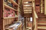 Rustic wooden staircase and shelving add character to this charming chalet.