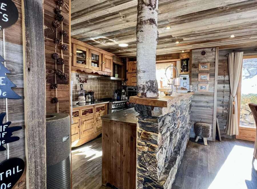 Rustic mountain chalet with a stunning stone and wood interior.