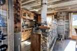 Rustic mountain chalet with a stunning stone and wood interior.