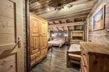Rustic wooden chalet bedroom with stunning mountain views.