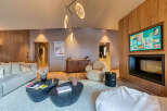 Experience luxury living in this stunning property, featuring a cozy living room with a modern fireplace and a stylish seating area.