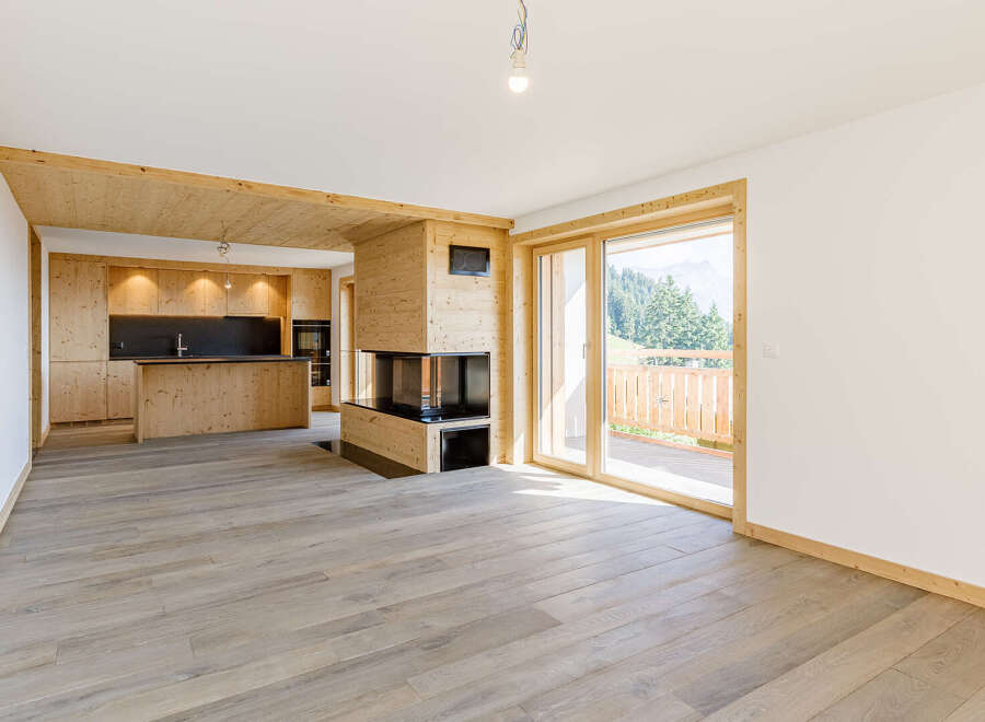 Experience the warmth of this stunning property, featuring a modern fireplace and a beautifully designed kitchen.