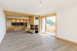Experience the warmth of this stunning property, featuring a modern fireplace and a beautifully designed kitchen.