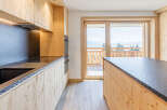 Experience the warmth of this stunning kitchen, featuring custom wood cabinetry and sleek countertops.