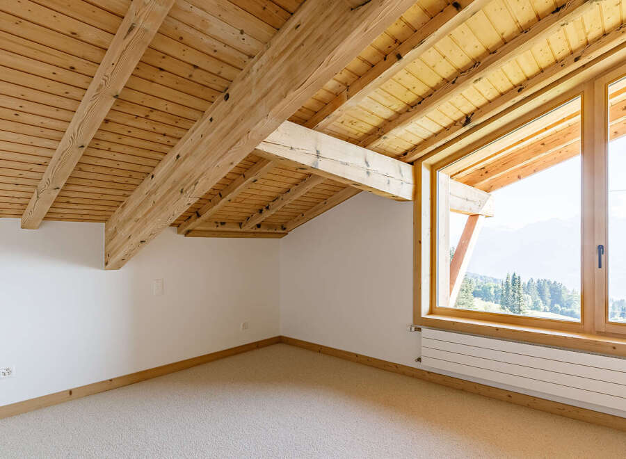 Discover the charm of this stunning attic space, featuring a beautifully crafted wooden ceiling and exposed beams.