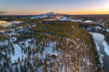 Experience the serene beauty of this winter wonderland, featuring a stunning aerial view of a snow-covered landscape.