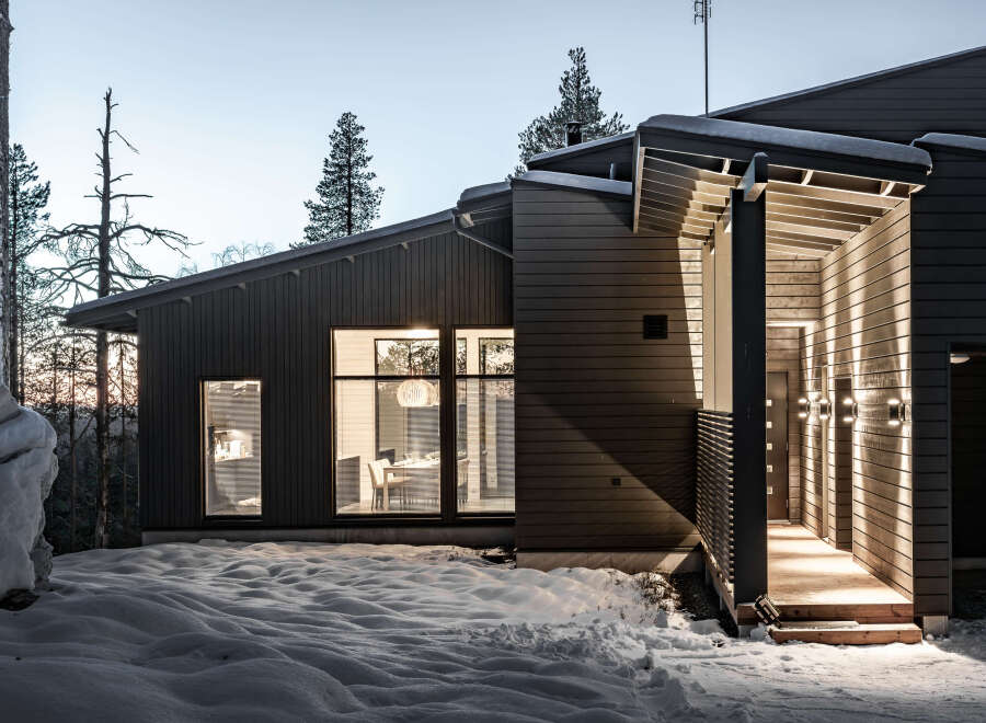Discover a stunning modern home nestled in a serene winter landscape.