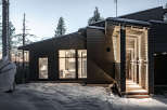 Discover a stunning modern home nestled in a serene winter landscape.
