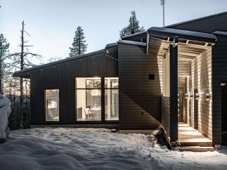 Discover a stunning modern home nestled in a serene winter landscape.