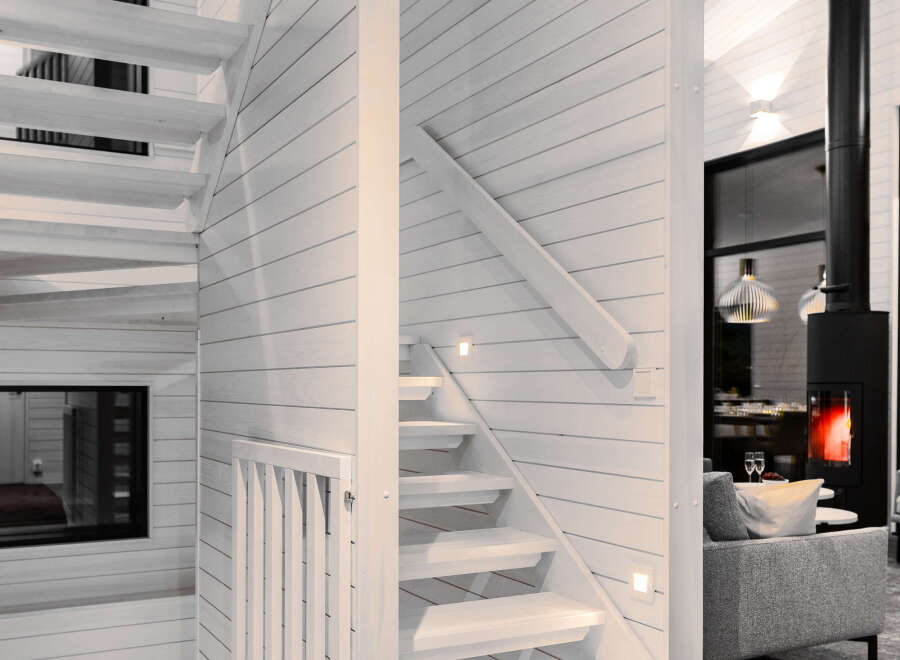This stunning property features a modern staircase with a minimalist design, seamlessly blending with the bright, airy interior.
