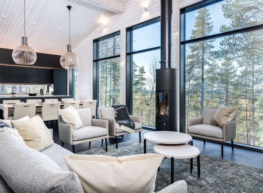 Experience modern luxury in this stunning home, featuring expansive windows that frame breathtaking views of the surrounding nature.