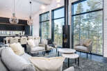 Experience modern luxury in this stunning home, featuring expansive windows that frame breathtaking views of the surrounding nature.