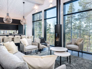 Experience modern luxury in this stunning home, featuring expansive windows that frame breathtaking views of the surrounding nature.