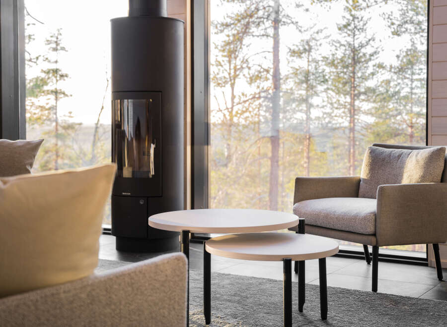 Experience cozy living in this inviting space, featuring a modern fireplace and a comfortable seating area.