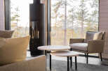 Experience cozy living in this inviting space, featuring a modern fireplace and a comfortable seating area.