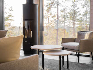 Experience cozy living in this inviting space, featuring a modern fireplace and a comfortable seating area.