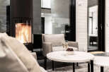 Cozy up in this modern living space, complete with a fireplace and comfortable seating.