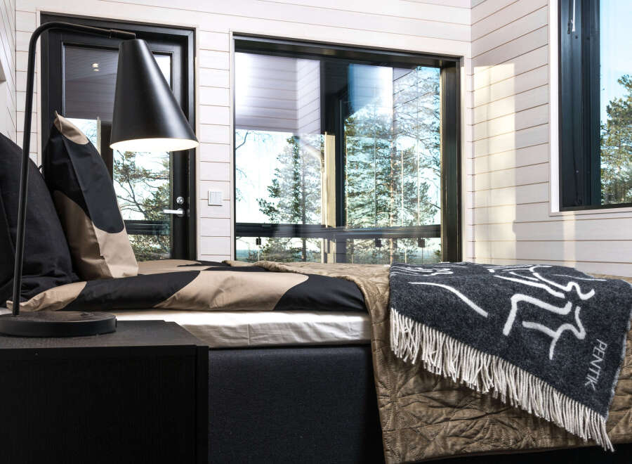 This cozy bedroom features a modern design with a touch of nature.
