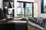 This cozy bedroom features a modern design with a touch of nature.