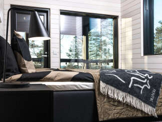 This cozy bedroom features a modern design with a touch of nature.