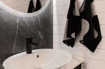 Modern bathroom design featuring a sleek black faucet and a stylish white sink.