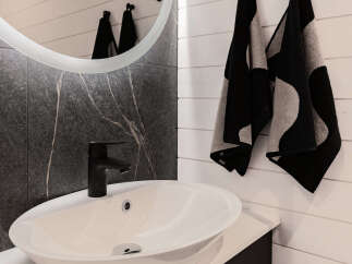 Modern bathroom design featuring a sleek black faucet and a stylish white sink.
