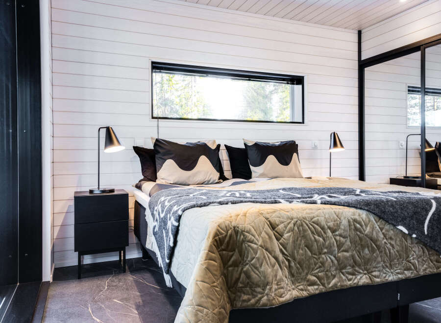This cozy bedroom features a modern design with a comfortable bed and stylish bedding.