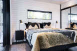 This cozy bedroom features a modern design with a comfortable bed and stylish bedding.