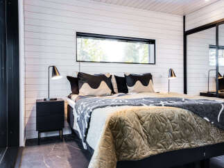 This cozy bedroom features a modern design with a comfortable bed and stylish bedding.