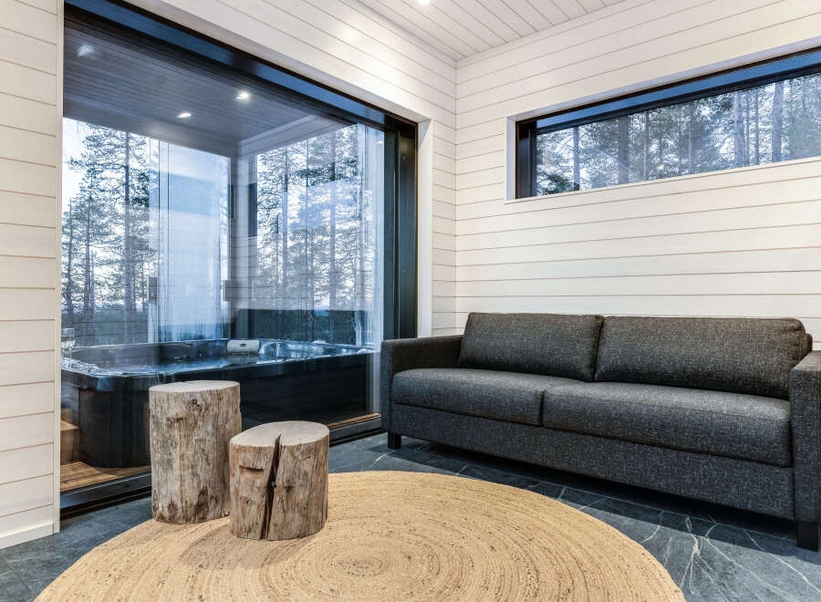 Relax in this luxurious space featuring a private hot tub and a cozy seating area.