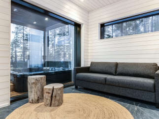 Relax in this luxurious space featuring a private hot tub and a cozy seating area.