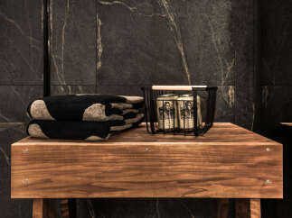 This luxurious bathroom features a sleek, modern design with dark marble accents.