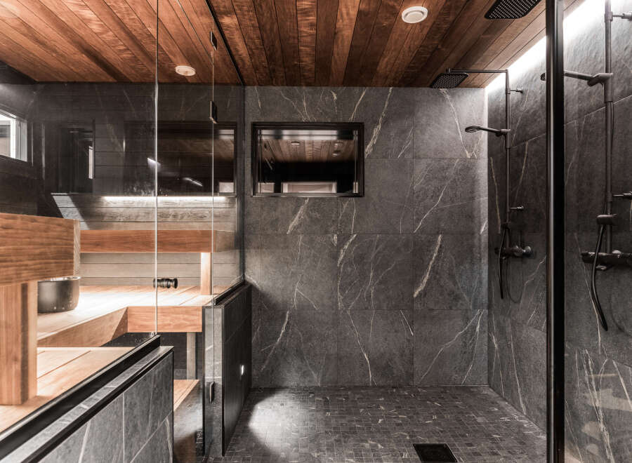 This luxurious bathroom features a stunning combination of wood and stone.