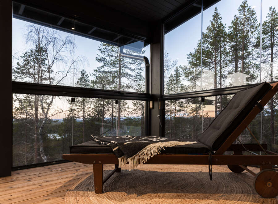 Experience tranquility in this stunning glass-enclosed space, offering panoramic views of the surrounding forest.
