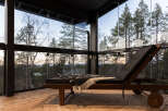 Experience tranquility in this stunning glass-enclosed space, offering panoramic views of the surrounding forest.