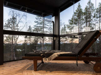 Experience tranquility in this stunning glass-enclosed space, offering panoramic views of the surrounding forest.