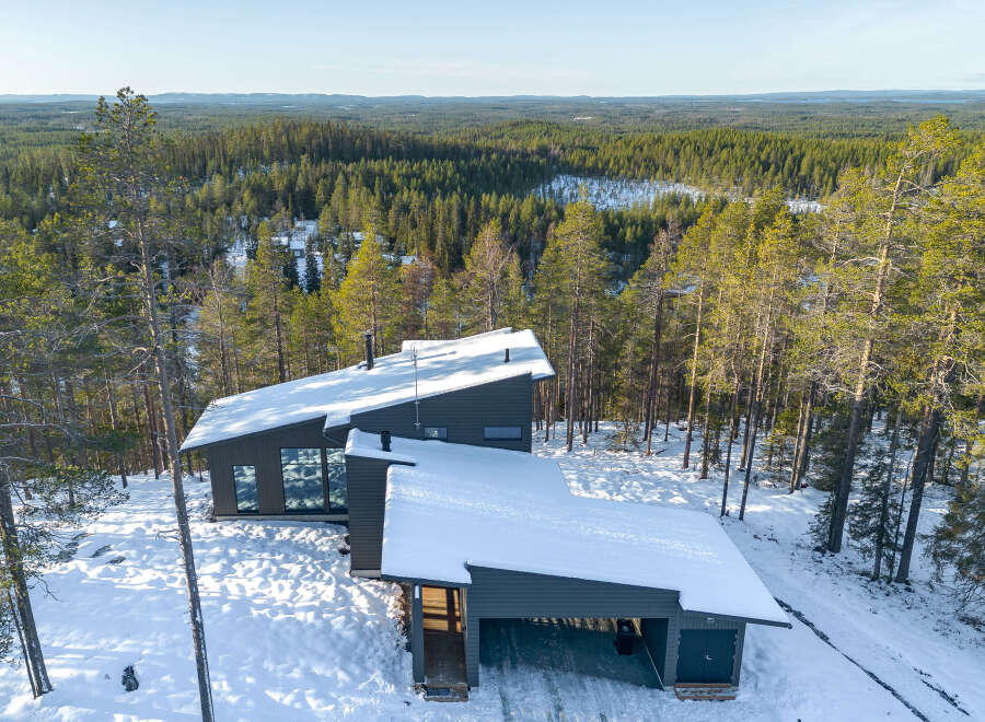 Discover a stunning modern home nestled in a serene winter wonderland.