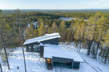 Discover a stunning modern home nestled in a serene winter wonderland.