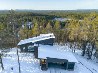 Discover a stunning modern home nestled in a serene winter wonderland.